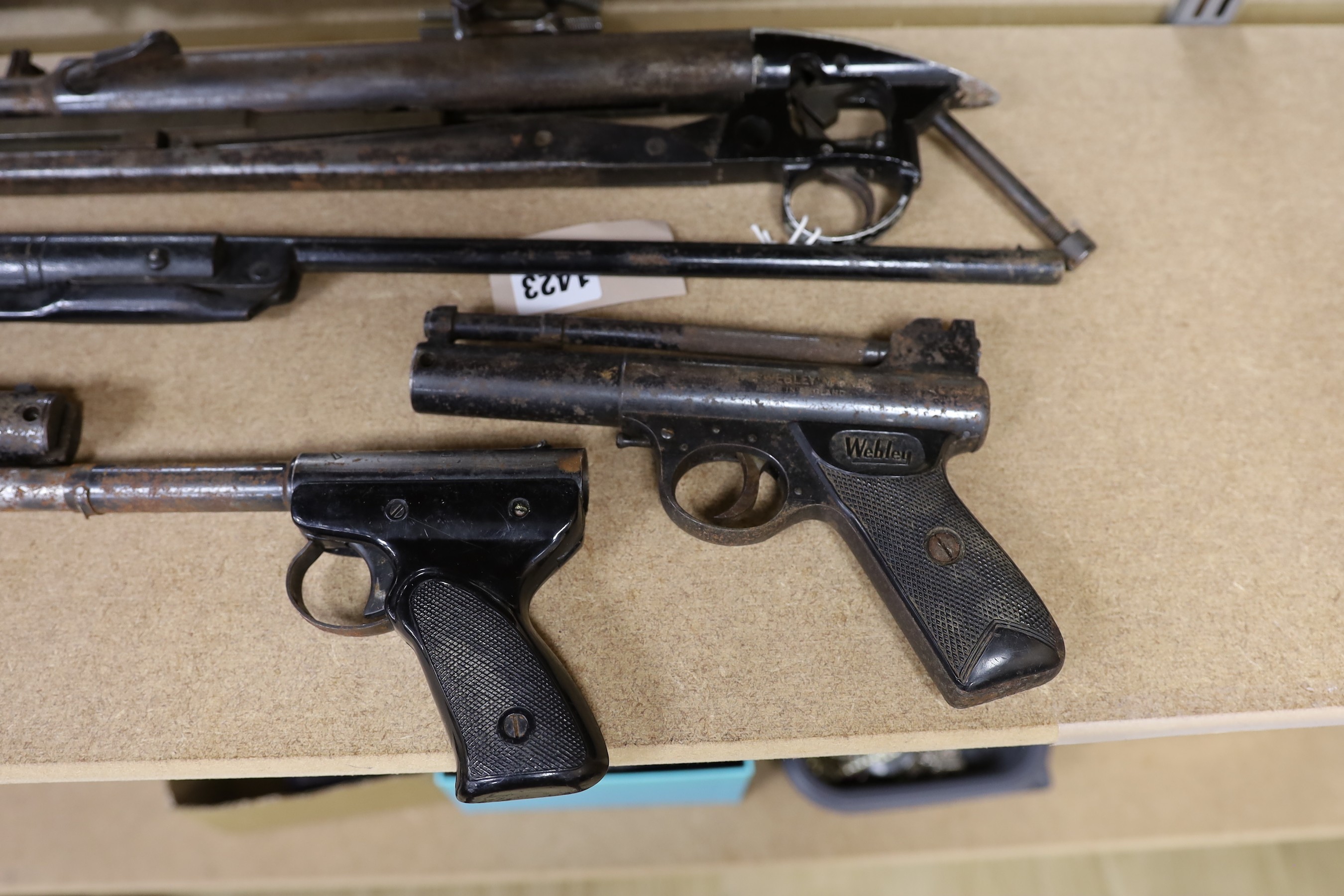 Two Webley air pistols, another, an air rifle and a part rifle